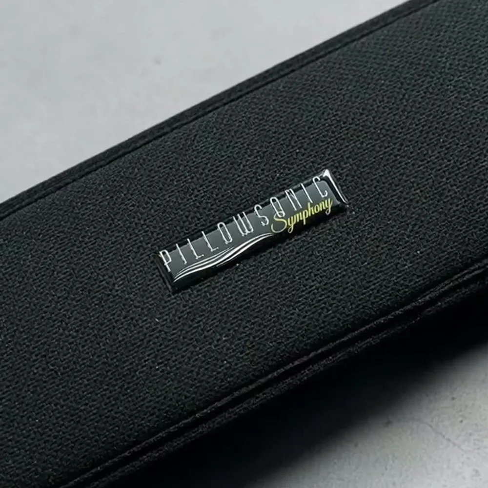 Close-up of the Pillowsonic Symphony label on its dark fabric speaker